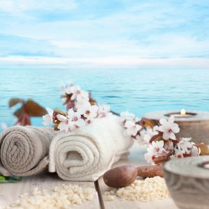 Spa and wellness setting with natural soap, candles and towel. Beige dayspa nature set